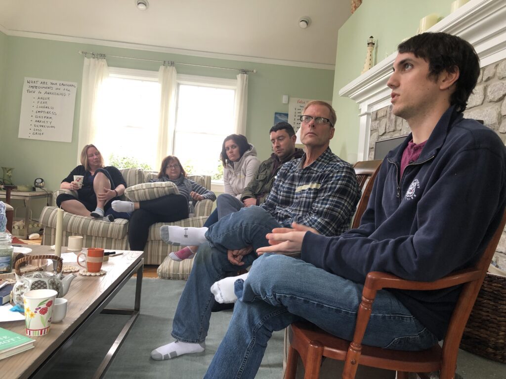 A group of people sitting in a living room.