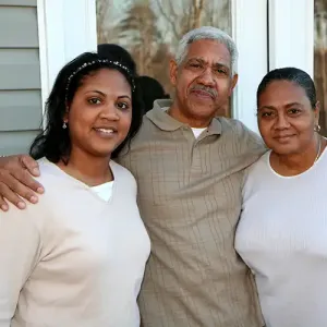 A Man Posing With Two Women in White