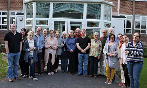 A group of people standing in front of a building.