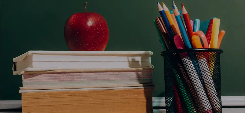 red apple and school supplies