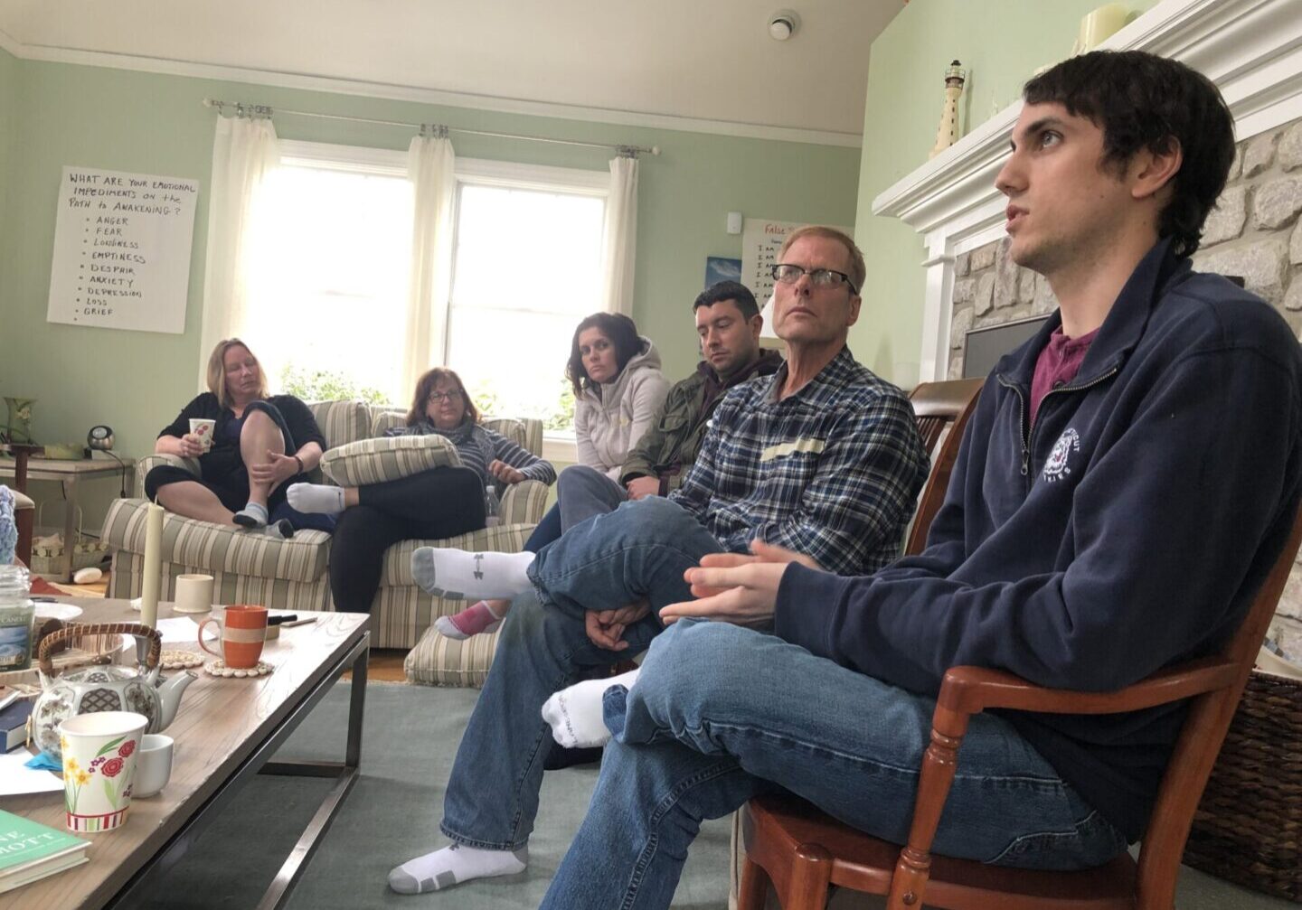 A group of people sitting in a living room.